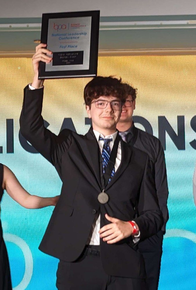 Jon Factor holding a first-place award at the BPA National Leadership Conference